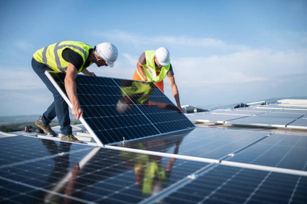 solar panel installation being done by two persons 